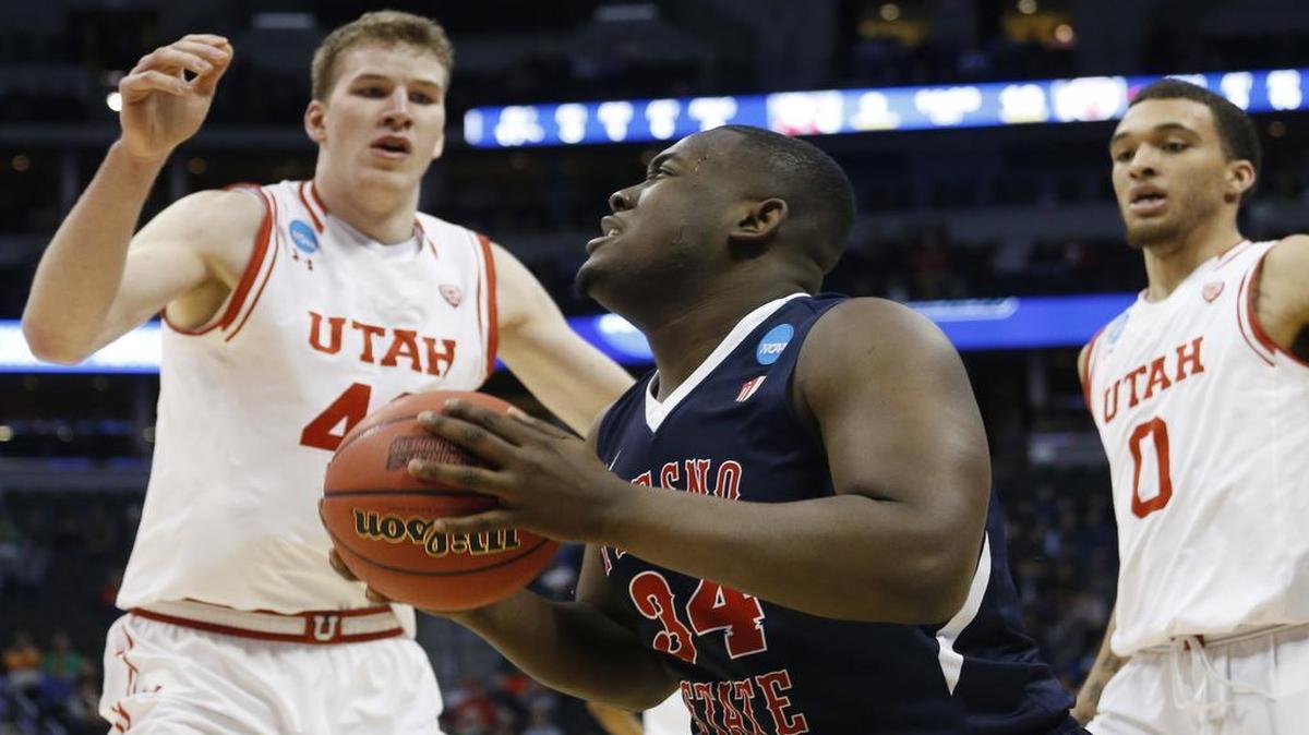 Fresno State center Terrell Carter II, front, goes up for a shot as Utah forwards Jakob Poeltl, back left, and Brekkott Chapman defend during the first half of their first-round NCAA Tournament game Thursday, March 17, 2016, in Denver.