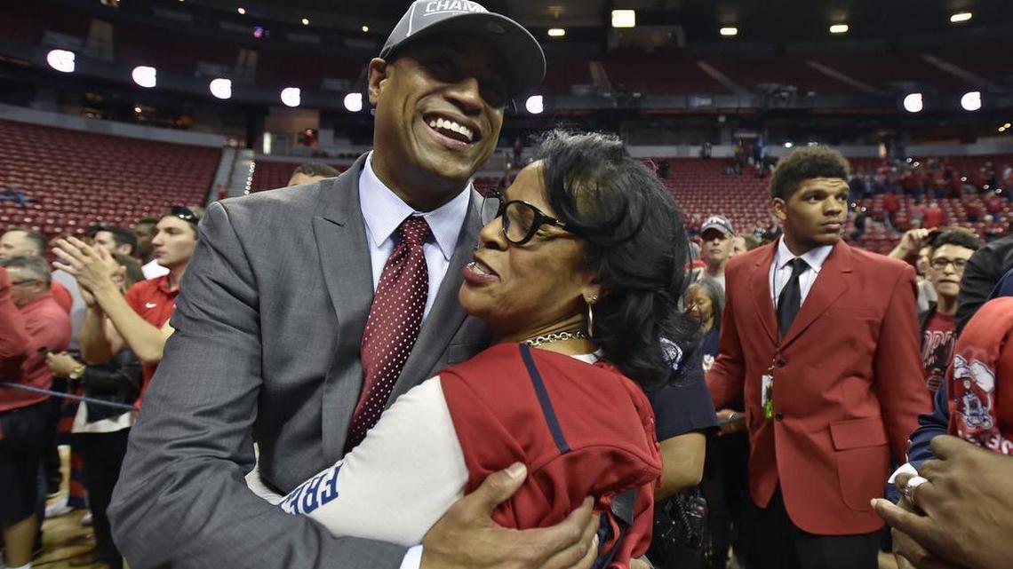 Fresno State coach Rodney Terry, left, gets a hug from his mother, Brenda Phillips, after the Bulldogs beat San Diego State 68-63 in Mountain West Tournament final Saturday, March 12, 2016, in Las Vegas.
