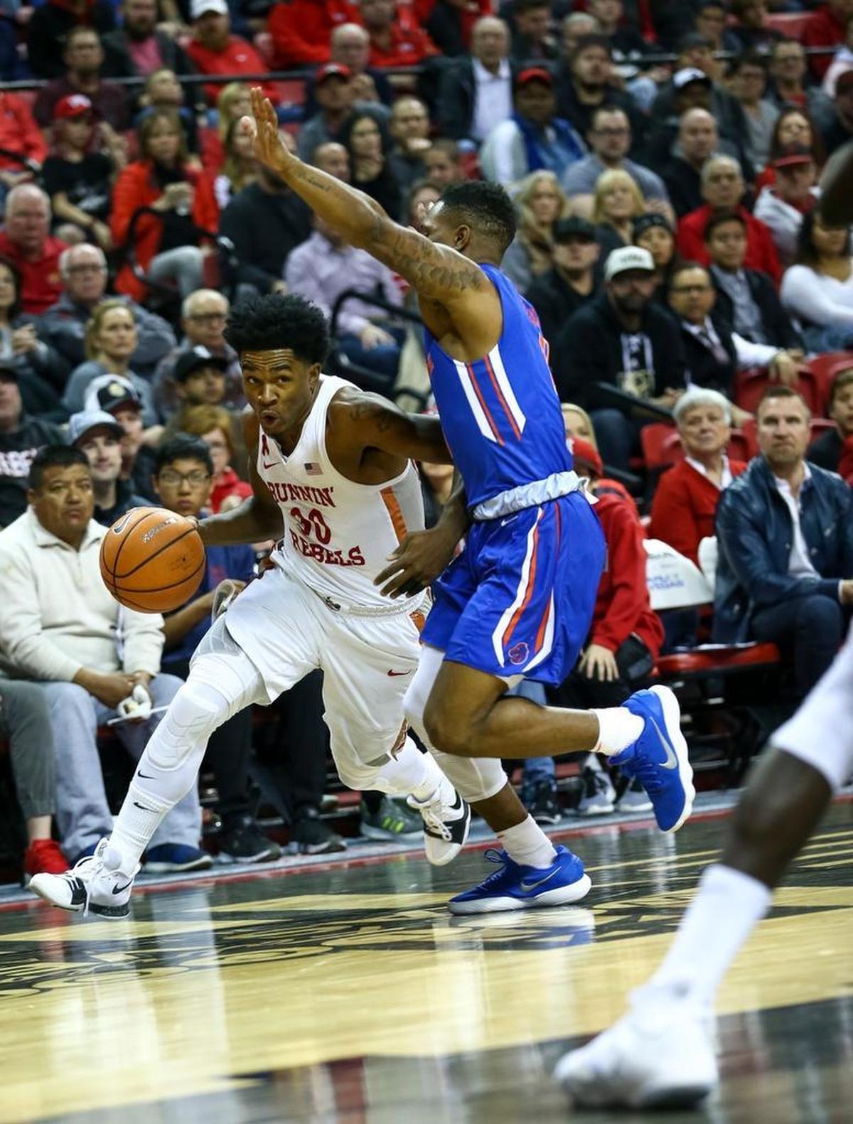 UNLV guard Jovan Mooring (30) pushes the ball up the floor and past Boise State guard Marcus Dickinson (0) during the Rebels’ 83-74 loss to the Broncos on Saturday, Dec. 30, 2017, in Las Vegas. UNLV is 0-3 at home and 3-0 on the road in Mountain West Conference play.