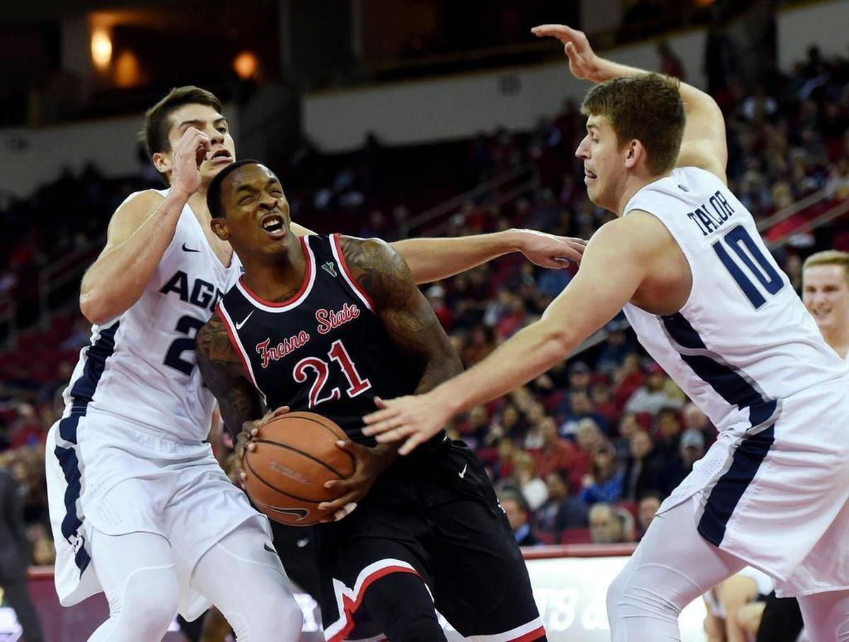 Fresno State guard Deshon Taylor, center, plans to go through the NBA Draft process this summer without hiring an agent to retain his eligibility and return to the Bulldogs next season. Taylor, a first-team All-Mountain West Conference selection, led Fresno State with 17.8 points per game.