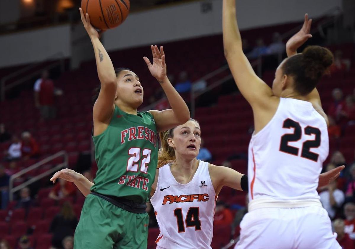 Fresno State point guard Aly Gamez gets a shot up over Pacific’s Jessica Blakeslee, center, and Valerie Higgins, right, in the Bulldogs’ 77-72 loss to the Tigers in the first round of the Women’s NIT Wednesday night, March 20, 2019 in Fresno.