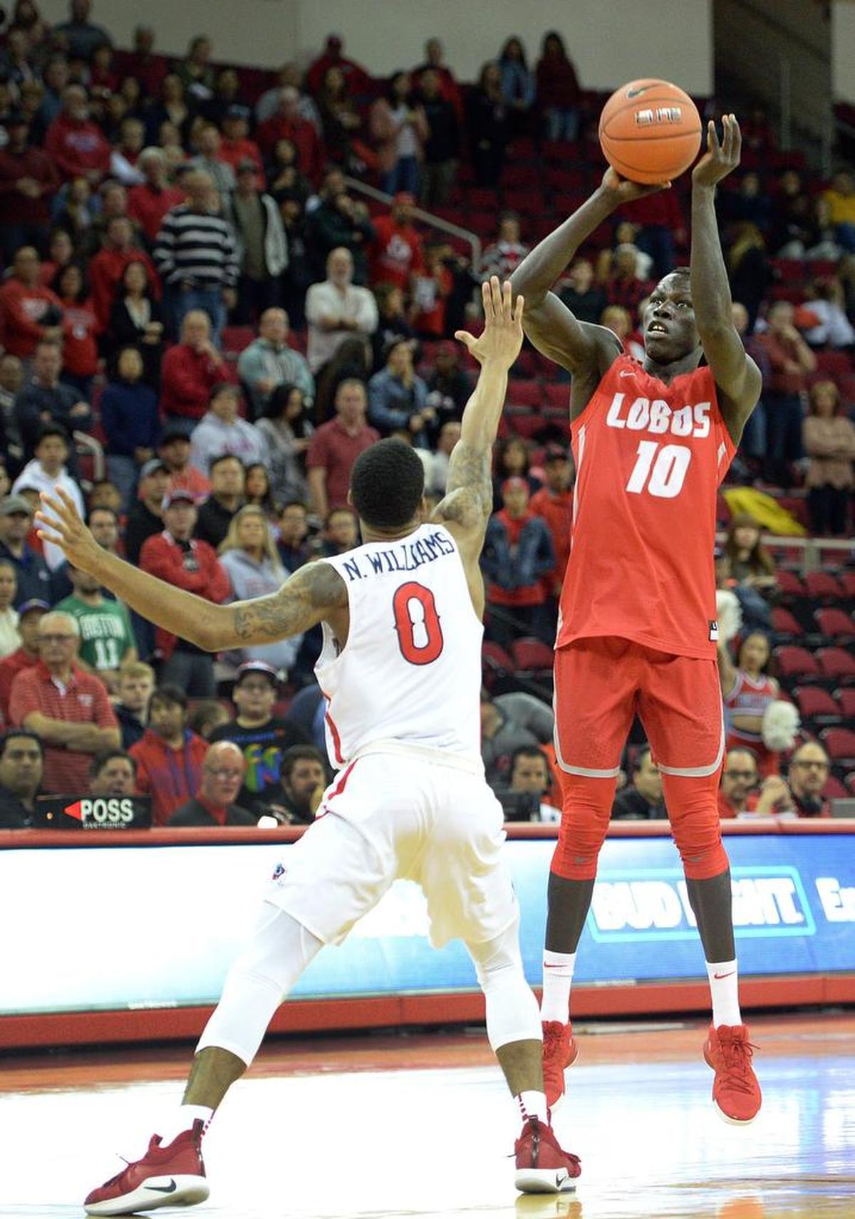 New Mexico guard Makuach Maluach, right, takes a jump shot with Fresno State’s New Williams defending during the Bulldogs’ 82-70 victory at the Save Mart Center in Fresno on Saturday, Feb. 2, 2019.