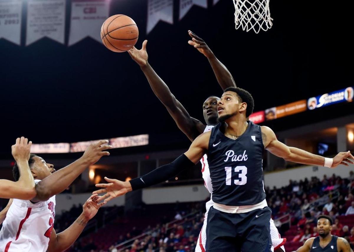 Fresno State forward Ray Bowles, Jr. left, and Terrell Carter, II, background fight for the rebound with Nevada's Hallice Cooke, right, in the Bulldogs’ 80-65 loss in their Mountain West Conference opener Wednesday, Dec. 27, 2017 in Fresno.