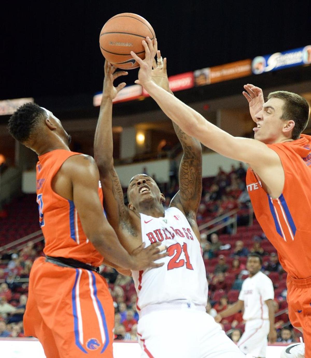 Fresno State guard Deshon Taylor (21) fights for a rebound between Boise State’s Marcus Dickinson, left, and Justinian Jessup during the Bulldogs’ 70-64 loss to the Broncos at the Save Mart Center in Fresno on Tuesday, Jan. 9, 2018. With the loss, Fresno State fell to 2-3 in Mountain West Conference play.