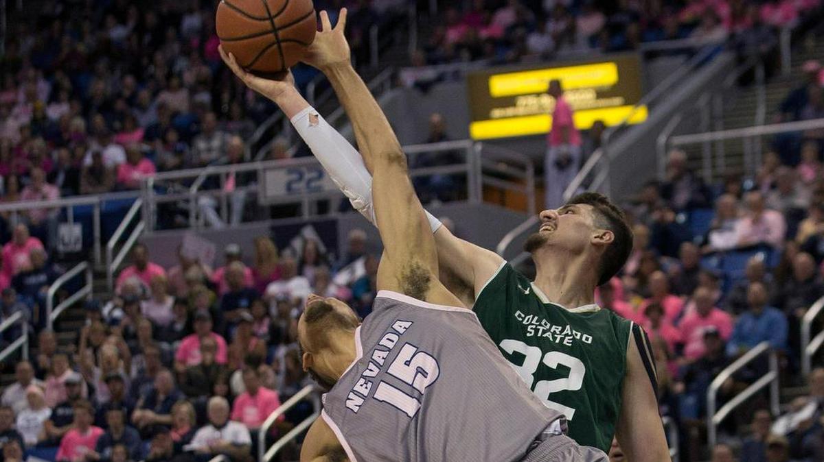 Colorado State center Nico Carvacho (32) reaches for a rebound in a game against Nevada, The 6-foot-11 junior is leading the Mountain West in scoring, rebounds and offensive rebounds in conference games.