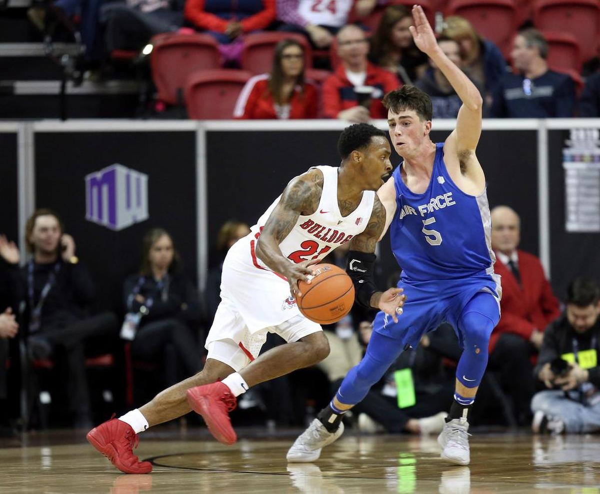 Fresno State’s Deshon Taylor (21) drives as Air Force’s Christopher Joyce (5) defends during the first half of an NCAA college basketball game in the Mountain West Conference men’s tournament Thursday, March 14, 2019, in Las Vegas. (AP Photo/Isaac Brekken)