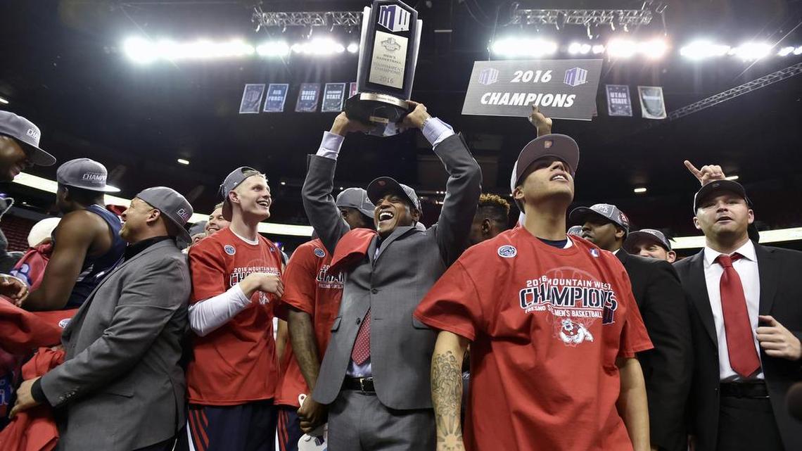 Fresno State coach Rodney Terry, center, celebrates with his players after the Bulldogs defeated San Diego State 68-63 in the Mountain West Tournament final on Saturday, March 12, 2016, in Las Vegas.