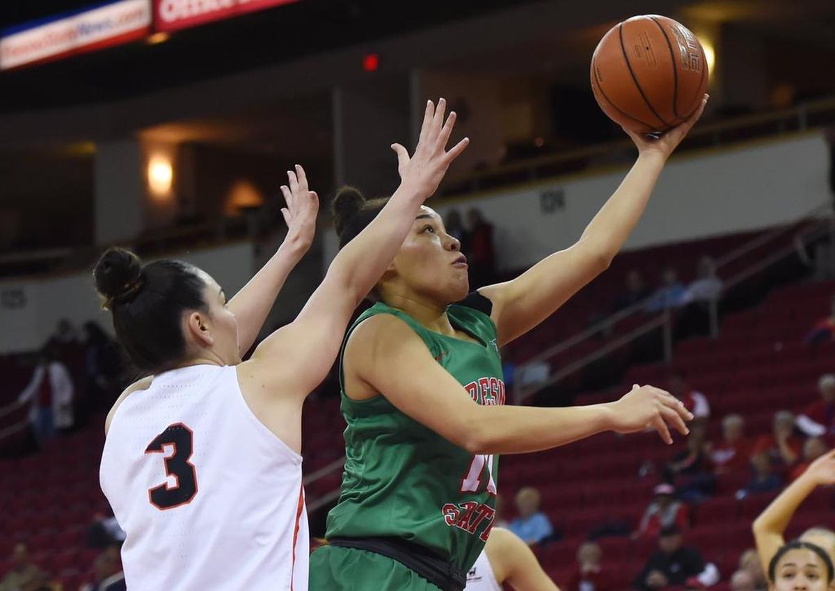 Fresno State’s Candice White shoots with Pacific’s Isabel Newman to the left in first-round Women’s NIT play Wednesday night, March 20, 2019 in Fresno. Fresno State lost 77-72.
