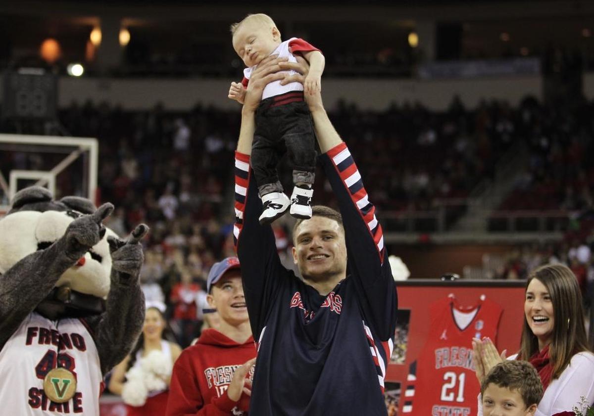 Fresno State guard Tyler Johnson holds his son Damien during a Senior Night celebration at the Save Mart Center in March 2014. Johnson was a sophomore on coach Rodney Terry’s first team at Fresno State and is now in his fourth season in the NBA with the Miami Heat.