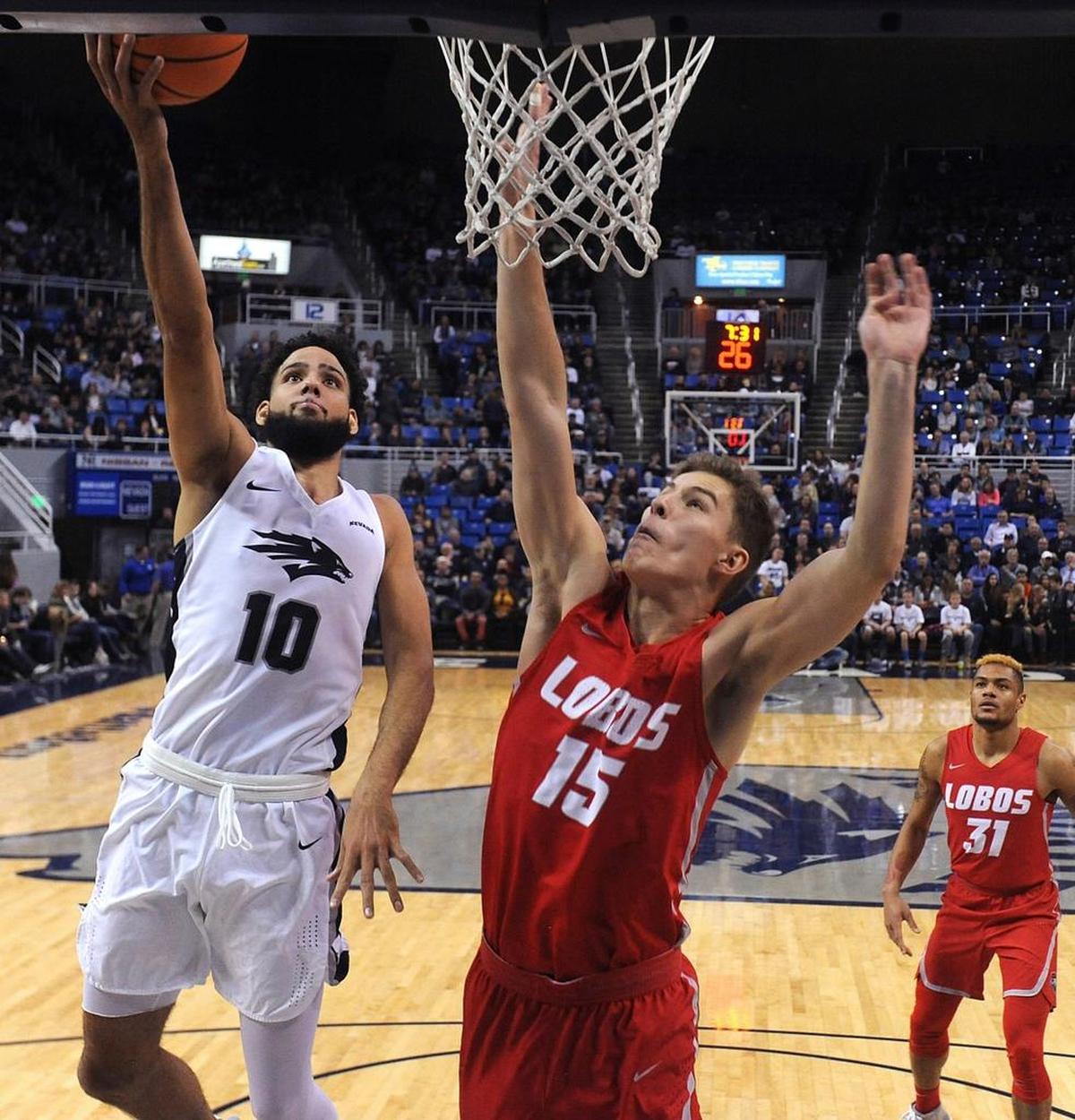 Nevada’s Caleb Martin (10) drives past New Mexico’s Vladimir Pinchuk (15) during the Wolf Pack’s 77-74 victory over the Lobos in Reno. Martin had a double-double with 18 points and 10 rebounds when Nevada won at Fresno State 80-65 on Dec. 27, 2017.