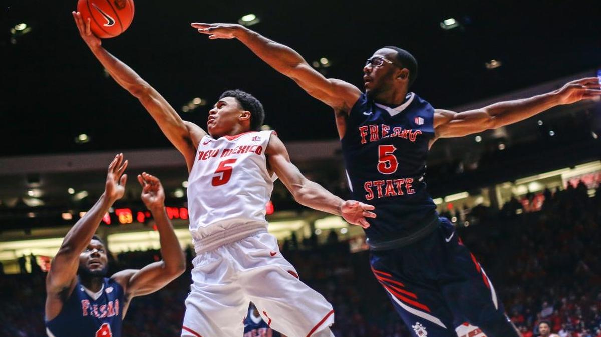 Fresno State forward Karachi Edo (4) and guard Jahmel Taylor contest a drive to the basket by New Mexico guard Jalen Harris in the second half of the Lobos’ 78-73 victory. New Mexico made 29 of 33 free throws in the game, compared to just 7 of 12 for the Bulldogs.