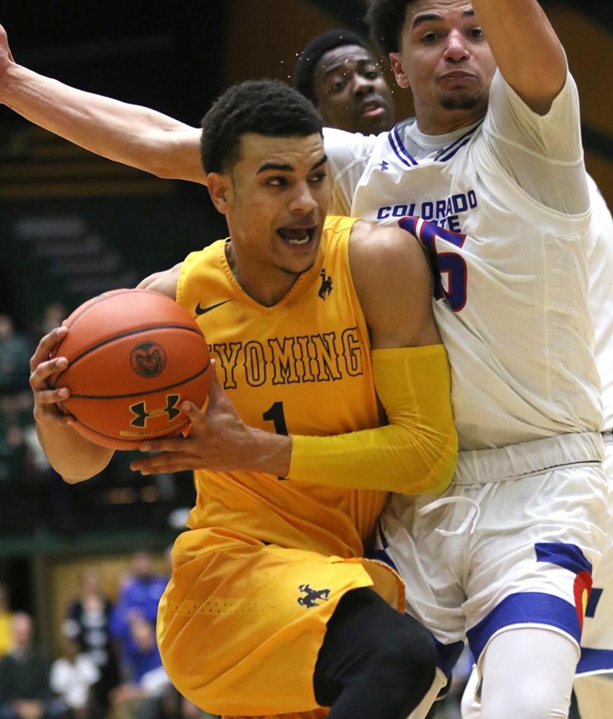 Wyoming guard Justin James muscles past Colorado State guard Anthony Bonner during the Cowboys’ 91-86 victory over the Rams in double overtime Wednesday, Jan. 31, 2018, in Fort Collins, Colo. James is fourth in the Mountain West in scoring at 19.1 points per game.