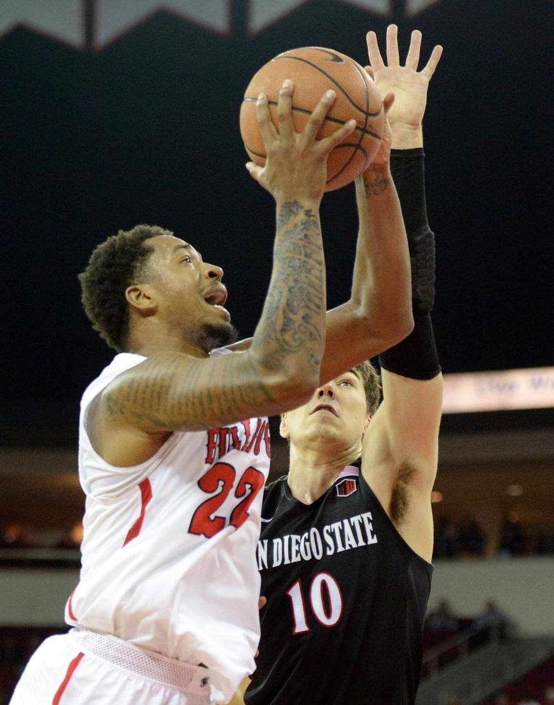 Fresno State guard Ray Bowles Jr., left, goes up for a shot at the hoop while guarded by San Diego State’s Max Montana in the Bulldogs’ 79-61 victory over the Aztecs at the Save Mart Center in Fresno on Tuesday, Feb. 6, 2018. Bowles had eight points, two rebounds, two assists and two steals.