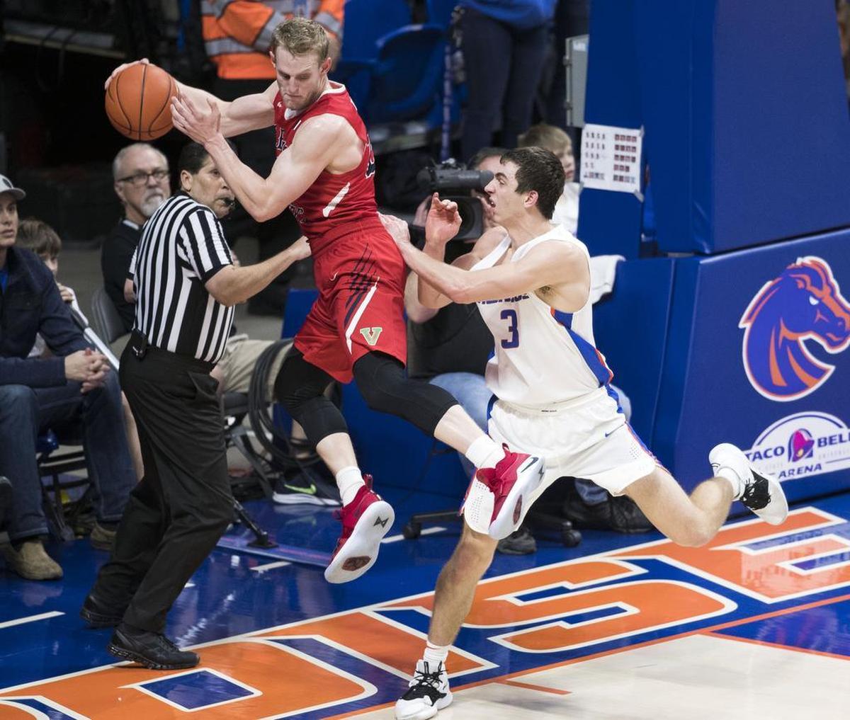 Fresno State forward Sam Bittner tries to save the basketball along the baseline against the defense of Boise State’s Justinian Jessup Saturday, Jan. 19, 2019 at Taco Bell Arena in Boise.