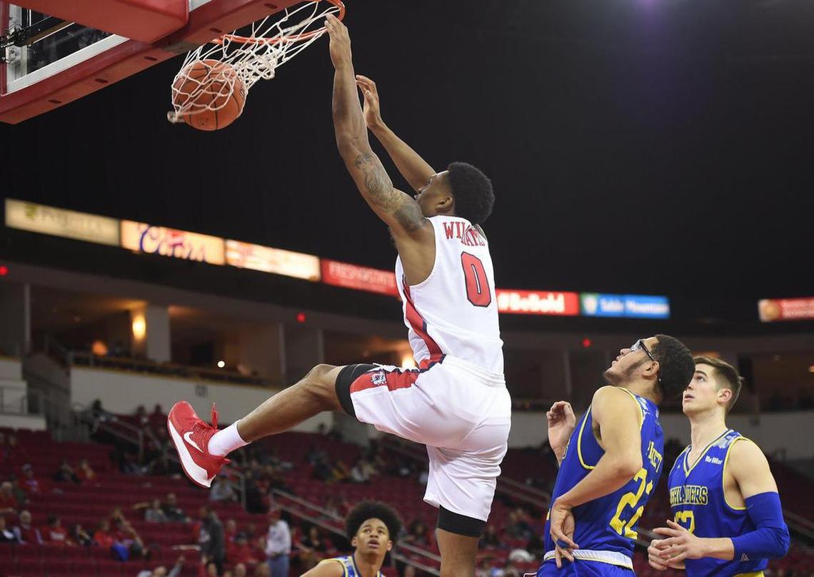 Fresno State guard New Williams dunks ahead of UC Riverside’s Dominick Pickett, right, and Angus McWilliam, far right, Saturday, Dec. 28, 2019 in Fresno. The Bulldogs had a 20-point lead with 9:42 to go, but lost 60-57.