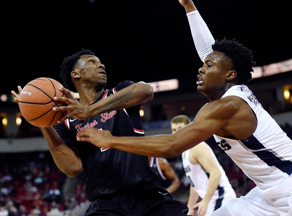 Utah State guard Koby McEwen, right, knocks the ball loose from Fresno State point guard Jaron Hopkins, left, in the Bulldogs’ 65-62 loss to the Aggies Saturday, Jan. 27, 2018 in Fresno. Hopkins had a double-double for Fresno State with 11 points and 11 rebounds.