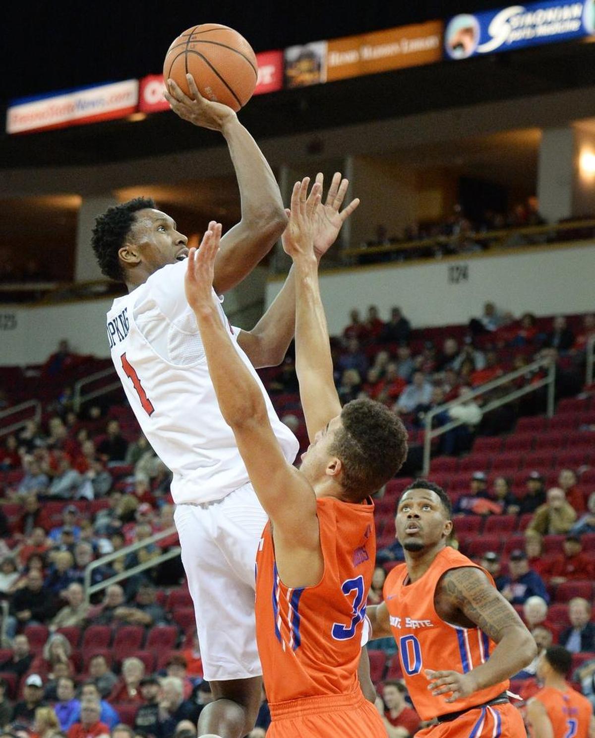 Fresno State point guard Jaron Hopkins, left, gets a shot up and over Boise State’s Justinian Jessup during the Bulldogs’ 70-64 loss to the Broncos at the Save Mart Center in Fresno on Tuesday, Jan. 9, 2018. Hopkins hit 5 of 7 shots and scored 11 points with five assists for the Bulldogs.