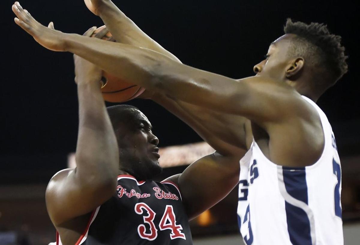 Fresno State center Terrell Carter II, left, is blocked by Utah State's Daron Henson, right, in a 65-62 loss to the Aggies on Saturday, Jan. 27, 2018 at the Save Mart Center in Fresno.