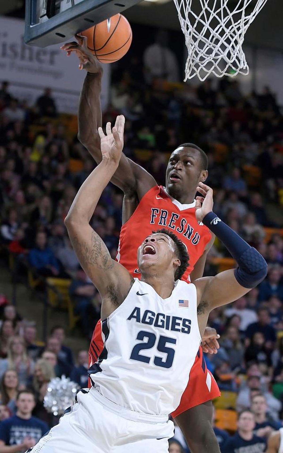 Fresno State forward Nate Grimes blocks a shot by Utah State forward Dwayne Brown Jr. (25) during the Bulldogs’ 81-79 overtime loss to the Aggies on Wednesday, Jan. 3, 2018, in Logan, Utah. Grimes had four points, 10 rebounds and two blocks in just 20 minutes.