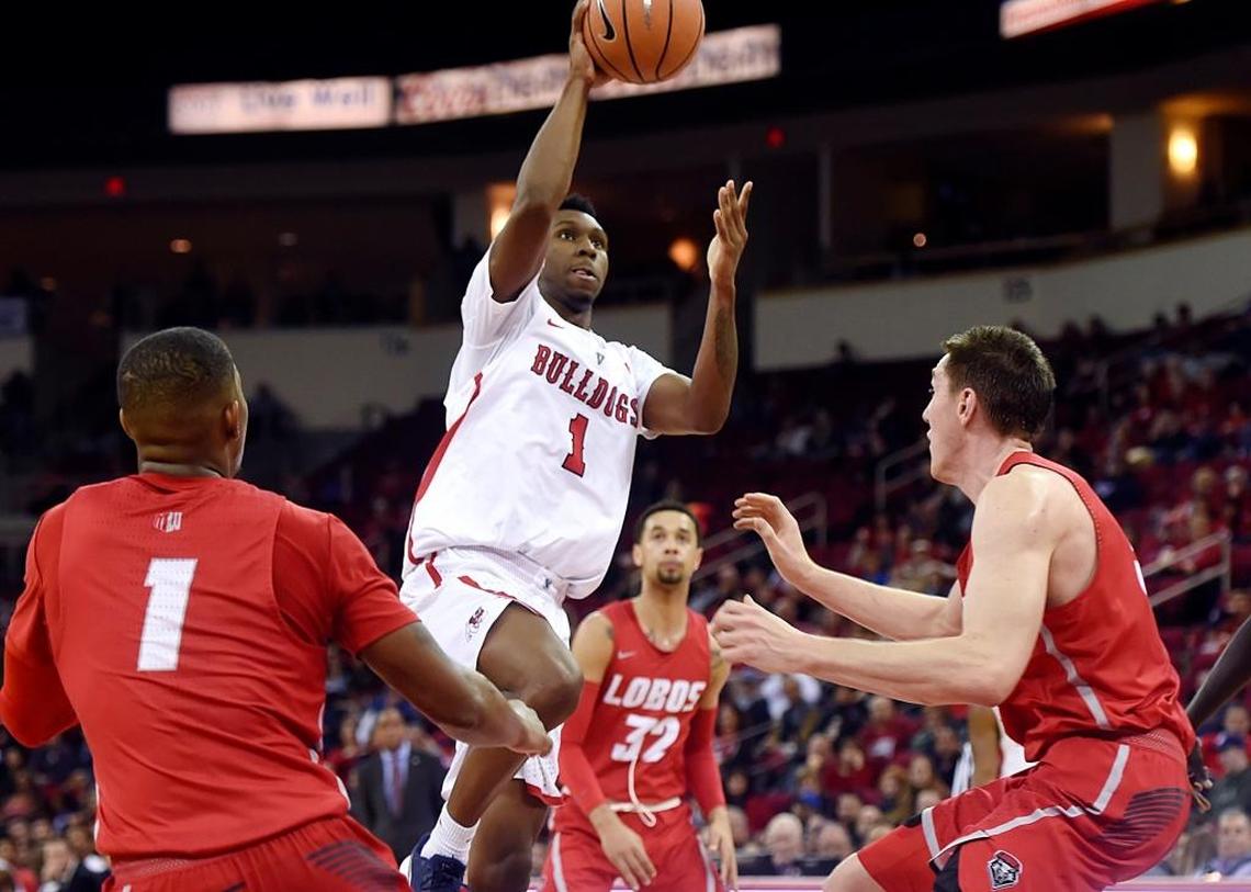 Fresno State point guard Jaron Hopkins (1) gets to the rim for a layup betwween New Mexico’s Chris McNeal, left, and Joe Furstinger, right, in the Bulldogs’ 89-80 victory over the Lobos Saturday, Jan. 13, 2018 in Fresno. The Bulldogs hit a Save Mart Center record 65.3 percent of their shots in the win.