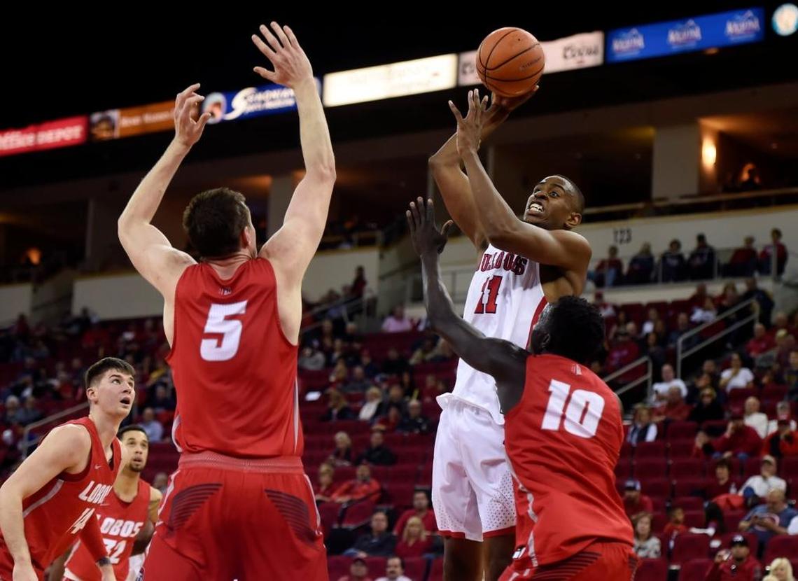 Fresno State forward Bryson Williams (11) gets a shot over New Mexico’s Joe Furstinger, left, and Makuach Maluach, right, in the Bulldogs’ 89-80 victory over the Lobos Saturday, Jan. 13, 2018 in Fresno. Williams hit 7 of 9 shots in scoring 15 points for the Bulldogs, who hit a Save Mart Center record 65.3 percent of their shots.