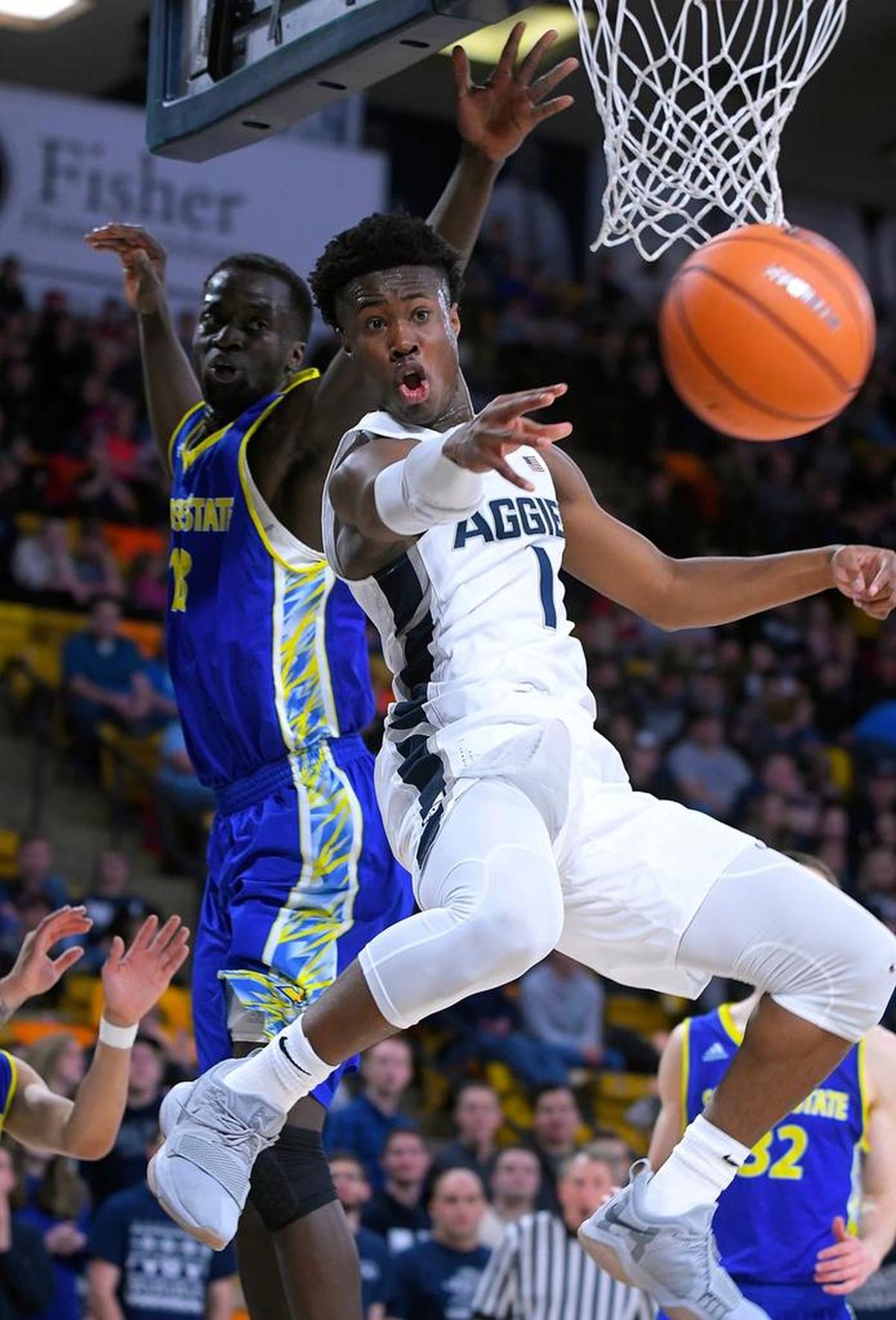 Utah State guard Koby McEwen (1) passes the ball as San Jose State center Oumar Barry (13) defends during the Aggies’ 86-72 victory over the Spartans Wednesday, Dec. 27, 2017, in Logan, Utah. McEwen is averaging 13.1 points per game for the Aggies.