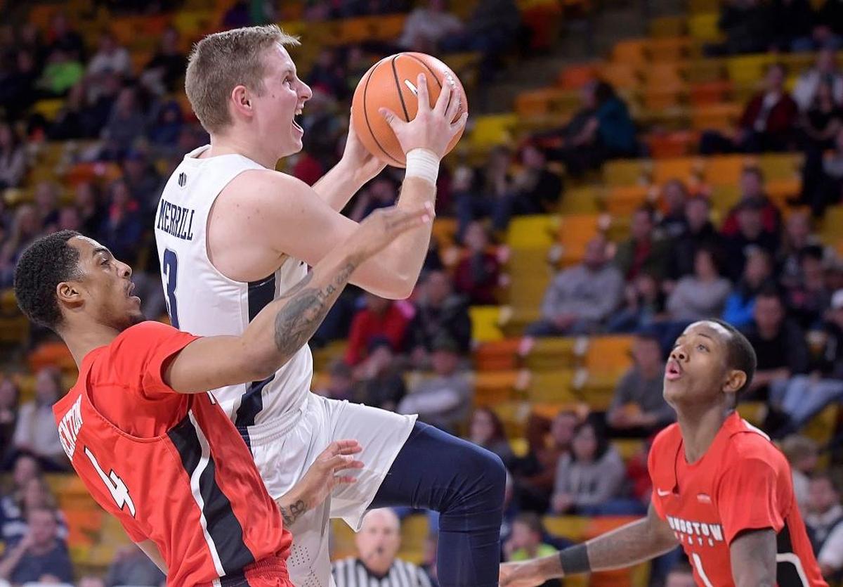 Utah State guard Sam Merrill (3) gets fouled by Youngstown State guard Jaylen Benton (4) as he drives to the basket as guard Braun Hartfield (1) helps defend during the Aggies’ 91-74 victory Wednesday Dec. 20, 2017, in Logan, Utah.