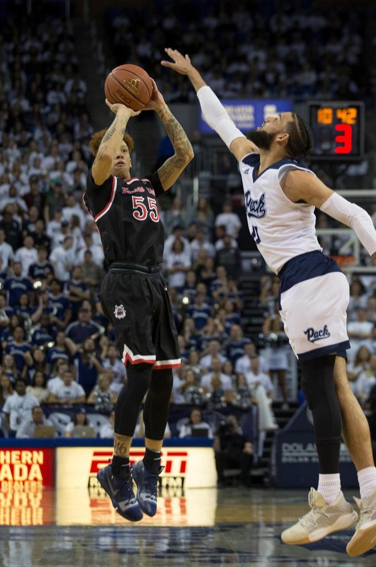 Fresno State guard Noah Blackwell (55) shoots over Nevada forward Cody Martin (11) in the first half of an NCAA college basketball game in Reno, Nev., Saturday, Feb. 23, 2019.