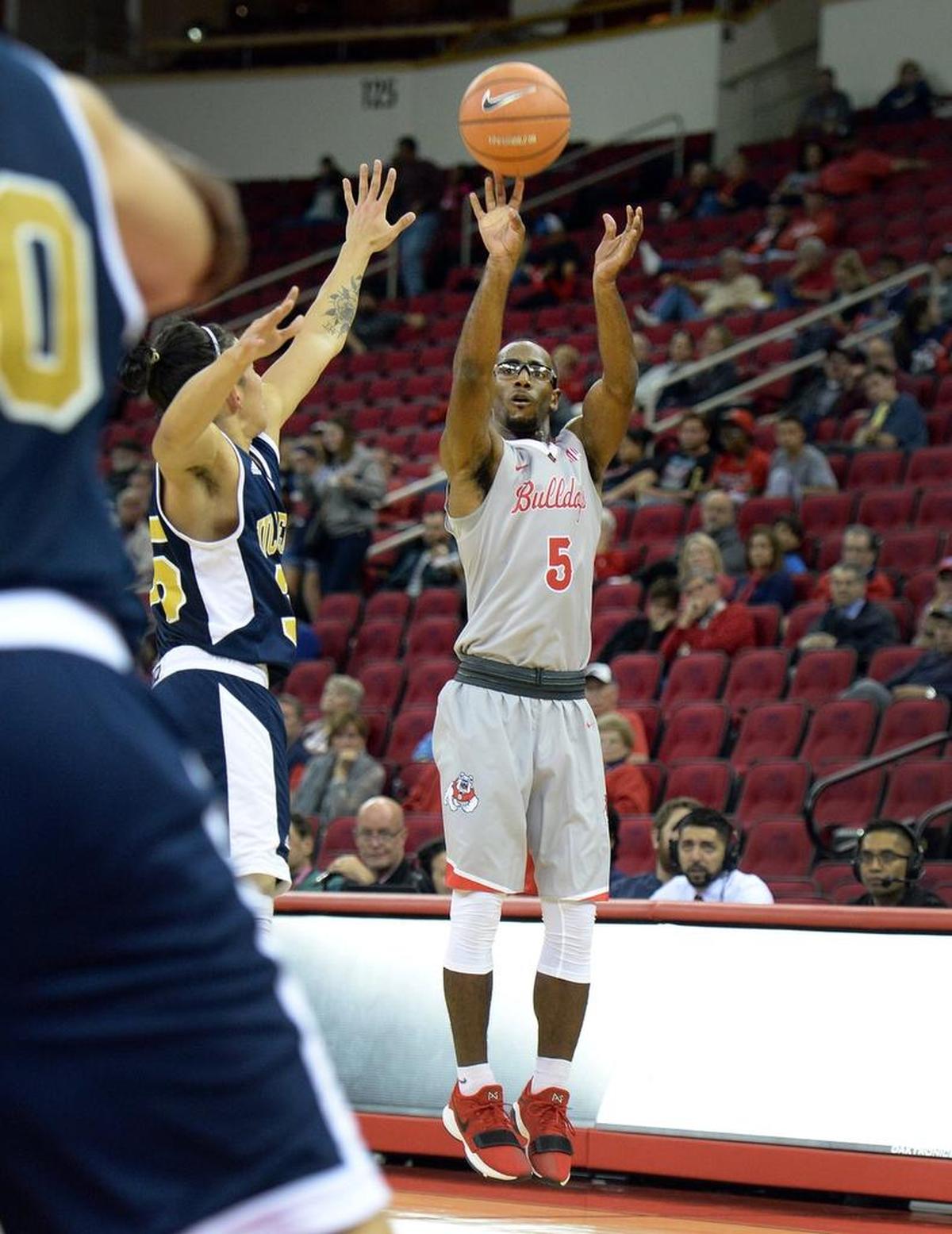 Fresno State guard Jahmel Taylor shoots a 3-pointer while defended by UC Merced’s Cole Taira during the Bulldogs’ 79-39 exhibition victory at Friday, Nov. 3, 2017, at Save Mart Center. Taylor has hit 46.4 percent of his shots from distance this season.