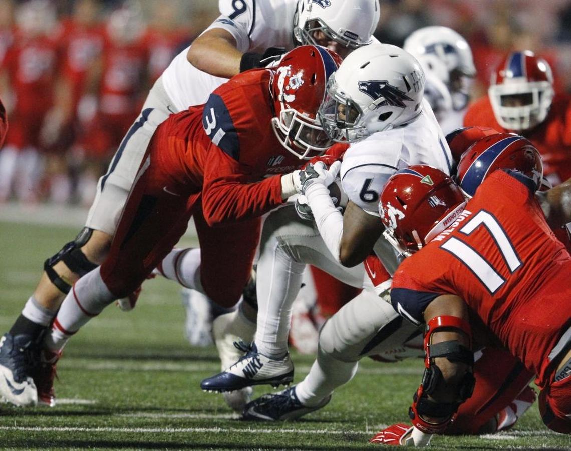 Fresno State’s Ejiro Ederaine takes down Nevada’s Don Jackson during the second half of the teams’ Nov. 5, 2015, game at Bulldog Stadium. Ederaine enters his career finale against Colorado State needing three tackles for loss to become the Mountain West Conference career leader.