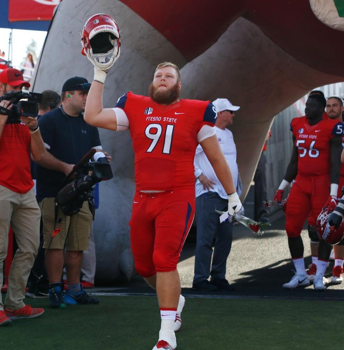 Fresno State defensive tackle Nate Madsen heads into the stadium on Senior Day before the Bulldogs’ 28-17 victory over Boise State on Saturday. Madsen suffered a right leg injury in the third quarter and will not play in the rematch with the Broncos in the Mountain West Conference championship game.