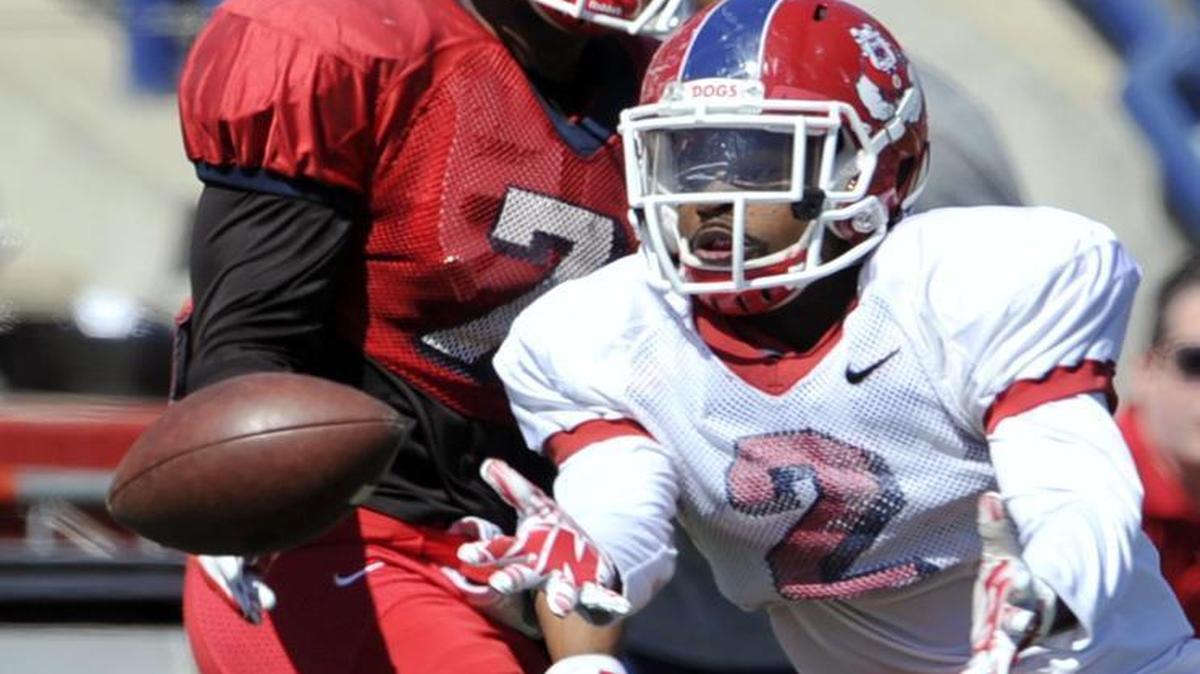 
Defensive back Jamal Ellis, right, tries to catch a missed throw to wide receiver Aaron Peck, left, during Fresno State’s Spring Showcase on March 28, 2015. The Bulldogs’ defensive back and receivers groups are both expected to improve this season, but the focus in fall camp is more so on a defensive backfield that yielded 54 pass plays of 20 or more yards last season and 31 pass plays of 30 or more yards. 
