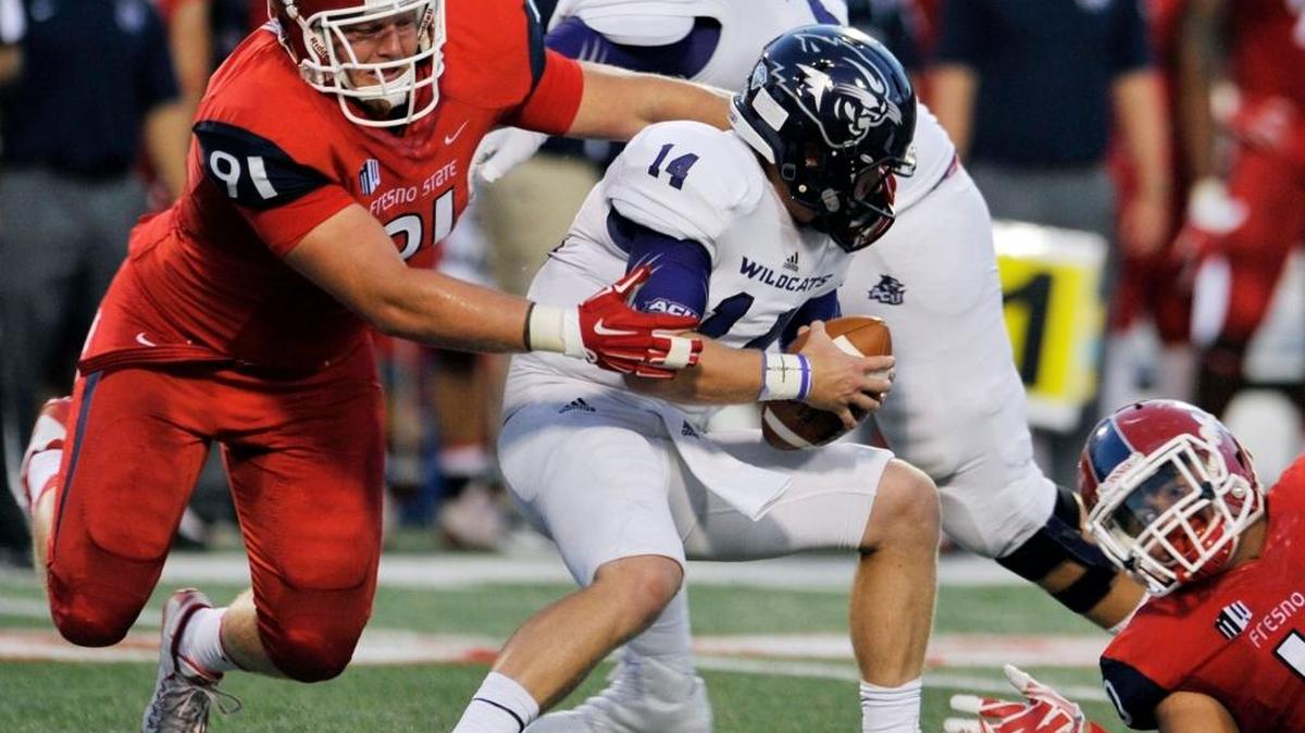 Fresno State’s Nate Madsen, left, pressures Abilene Christian quarterback Parker McKenzie in first-half action of the teams’ Sept. 3, 2015, game at Bulldog Stadium. Madsen finished with 19 tackles in 11 games last season, including 3.5 behind the line of scrimmage.