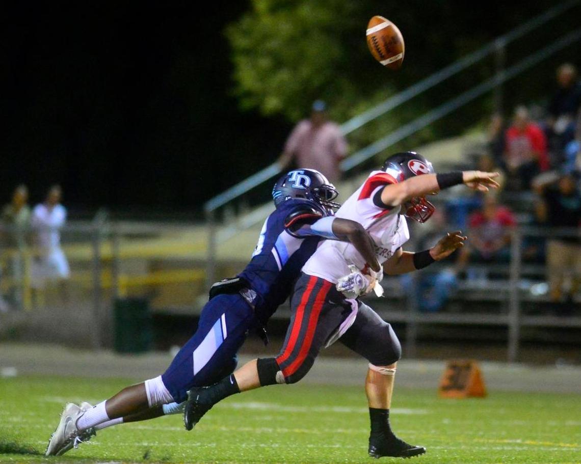 Modesto-Downey defensive end Isaiah Johnson sacks and forces a fumble by Patterson High’s Kevin Todd on Sept. 2, 2016. Johnson is one of 15 players to sign a national letter of intent with Fresno State during the early signing period.