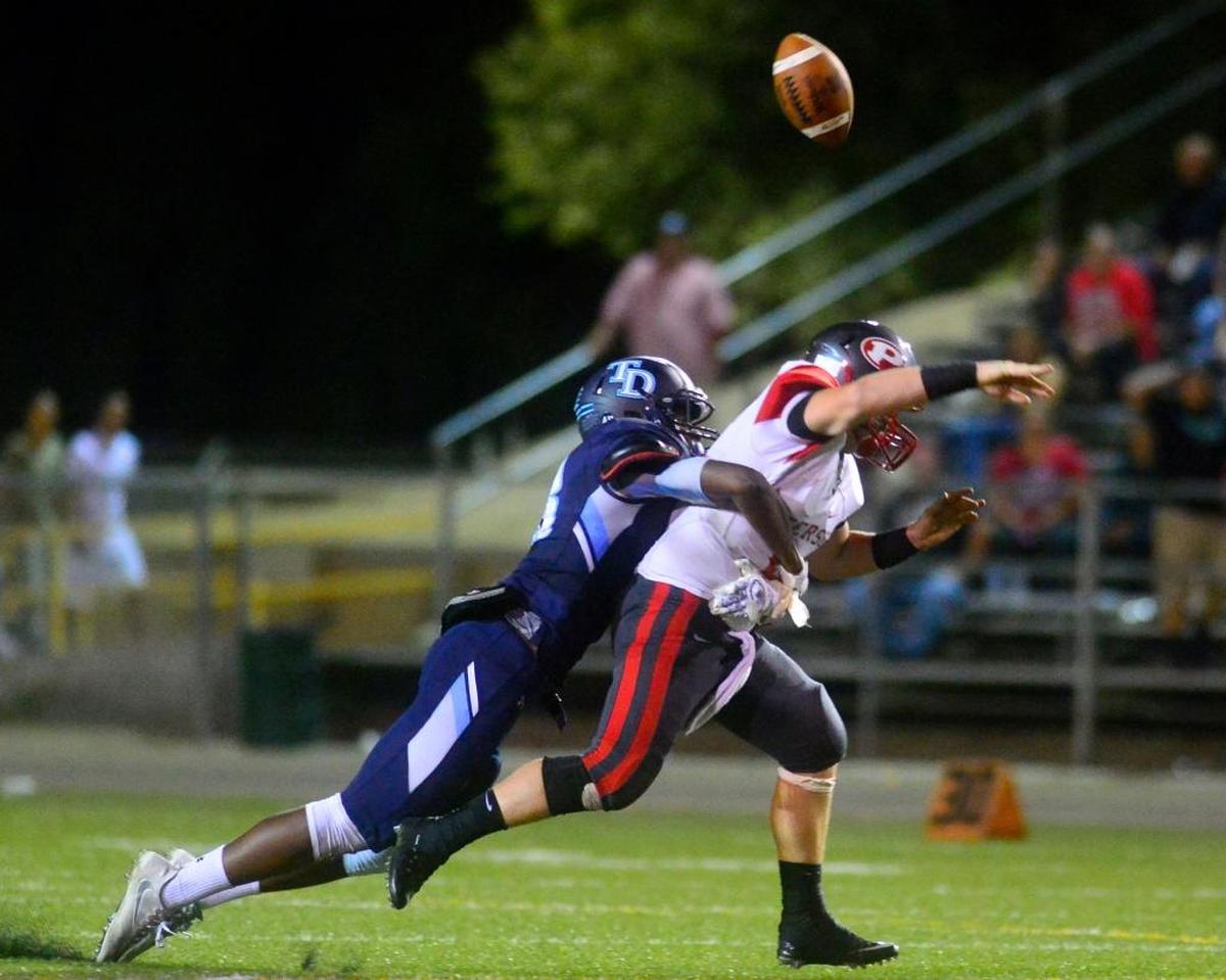 Modesto-Downey defensive end Isaiah Johnson sacks and forces a fumble by Patterson High’s Kevin Todd on Sept. 2, 2016. Johnson is one of 15 players to sign a national letter of intent with Fresno State during the early signing period.
