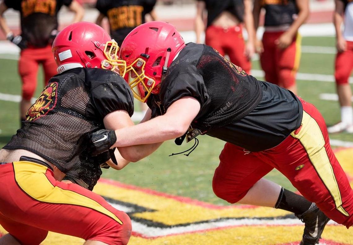 Oakdale High defensive lineman Matt Kjeldgaard, right, works out with a teammate during practice in Oakdale on Thursday, August 18, 2016. Kjeldgaard signed a national letter of intent with Fresno State and is a key piece with the Bulldogs losing five of their top defensive lineman after this season.