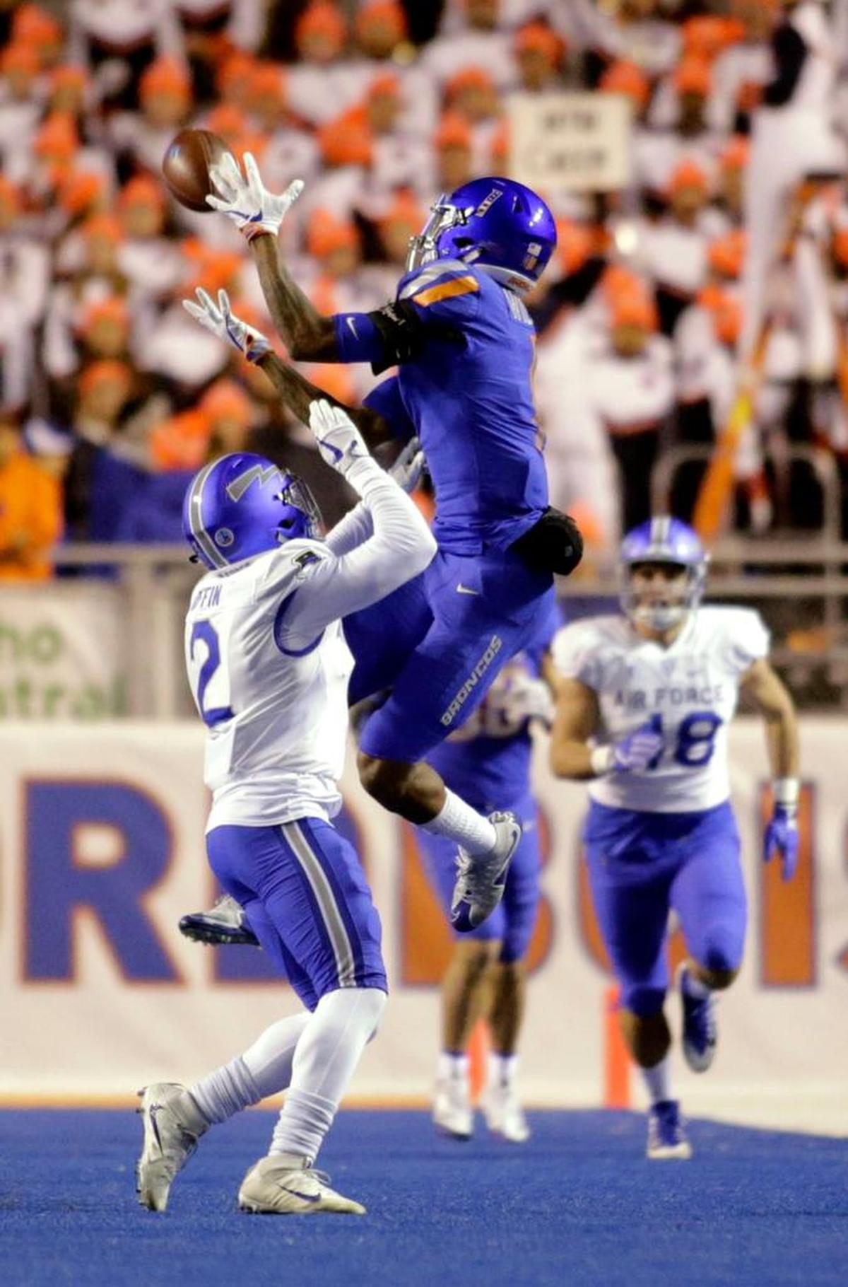 Boise State wide receiver Cedrick Wilson makes a catch over Air Force defensive back Marquis Griffin (2) during the Broncos 44-19 victory over the Falcons, Saturday, Nov. 18, 2017, in Boise, Idaho. This season Wilson is averaging 17.4 yards on his 58 receptions and has caught six touchdown passes.