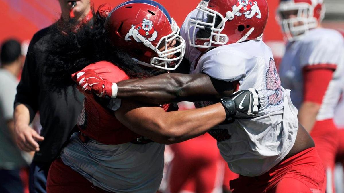 
Offensive lineman Alex Fifita, left, wrangles with defensive end Claudell Louis, right, in the Bulldog Drill during practice. Fifita has risen from humble beginnings as a freshman to becoming a rock on the Bulldogs’ offensive line as a senior. 
