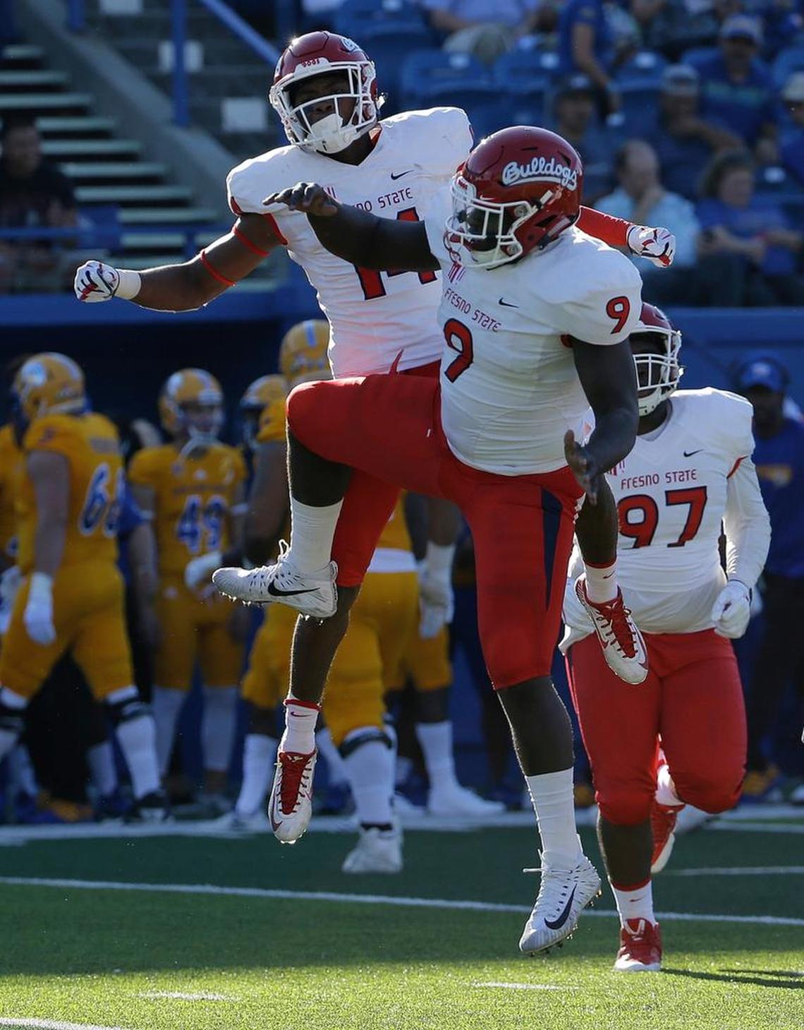 Fresno State linebacker Jeffrey Allison (9) and defensive back Jaron Bryant (14) celebrate after Bryant picked off a pass in a 27-10 victory over the Spartans in San Jose, Saturday, Oct. 7, 2017. The Bulldogs last season ranked second in the Mountain West in scoring and total defense and next season return their top seven tacklers.