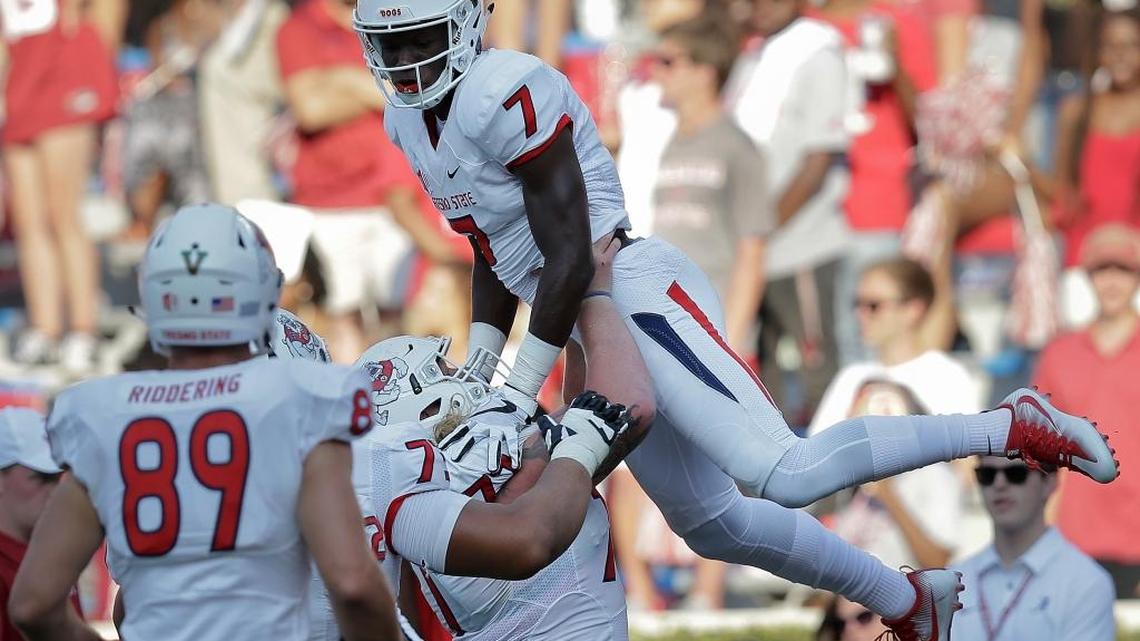 Fresno State wide receiver Derrion Grim is lifted up by Fresno State offensive lineman Micah St. Andrew after Grim scores a touchdown in the second half of an NCAA college football game Sept. 9 in Tuscaloosa, Ala. Grim could provide a bigger jolt to the Bulldogs’ passing game as he and quarterbacks Chason Virgil and Marcus McMaryion gain more experience working together.
