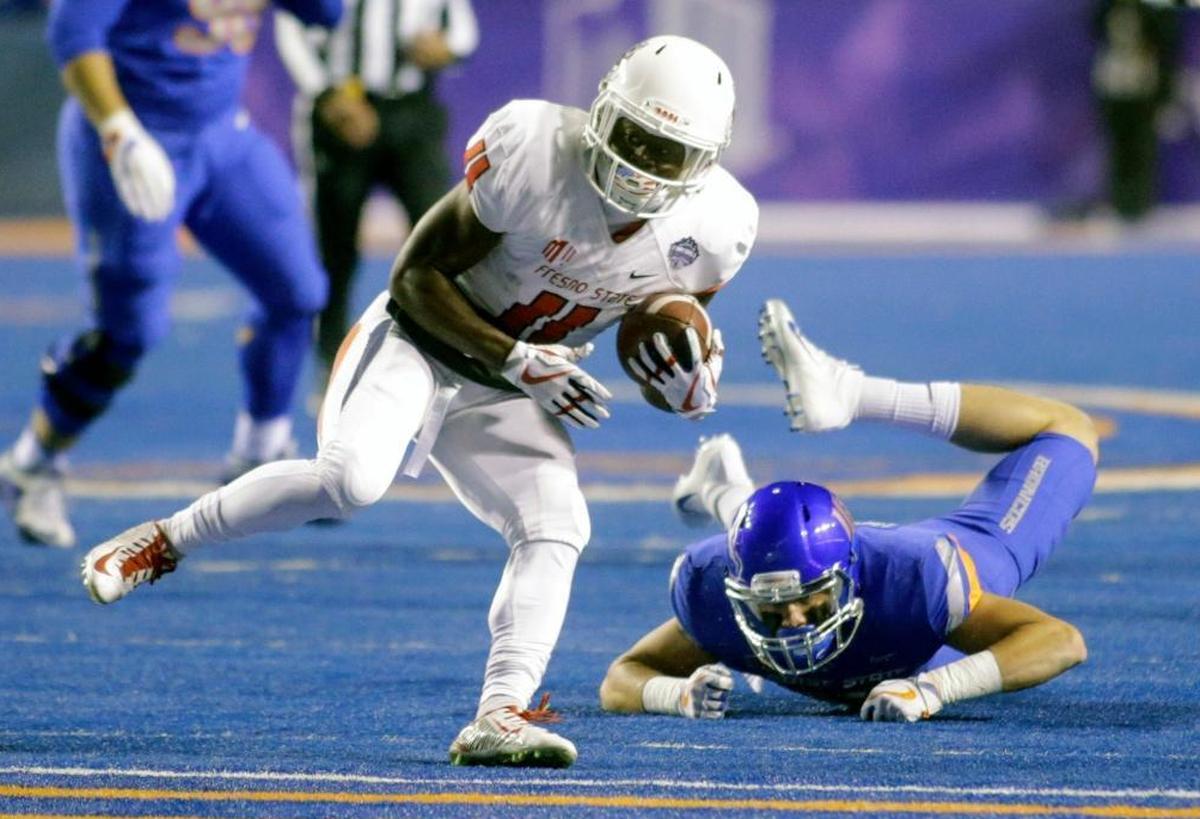Fresno State running back Dejonte O’Neal eludes Boise State safety Kekoa Nawahine during the first half of the Broncos’ 17-14 victory over the Bulldogs in the Mountain West Conference Championship Saturday, Dec. 2, 2017 at Albertsons Stadium in Boise.