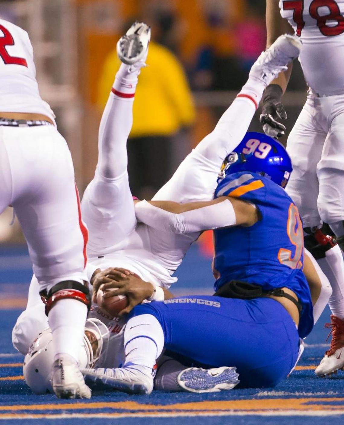 Fresno State quarterback Marcus McMaryion (6) is upended by Boise State defensive end Curtis Weaver on a sack in the Broncos’ 17-14 victory over the Bulldogs in the Mountain West Conference Championship Saturday, Dec. 2, 2017 at Albertsons Stadium in Boise.