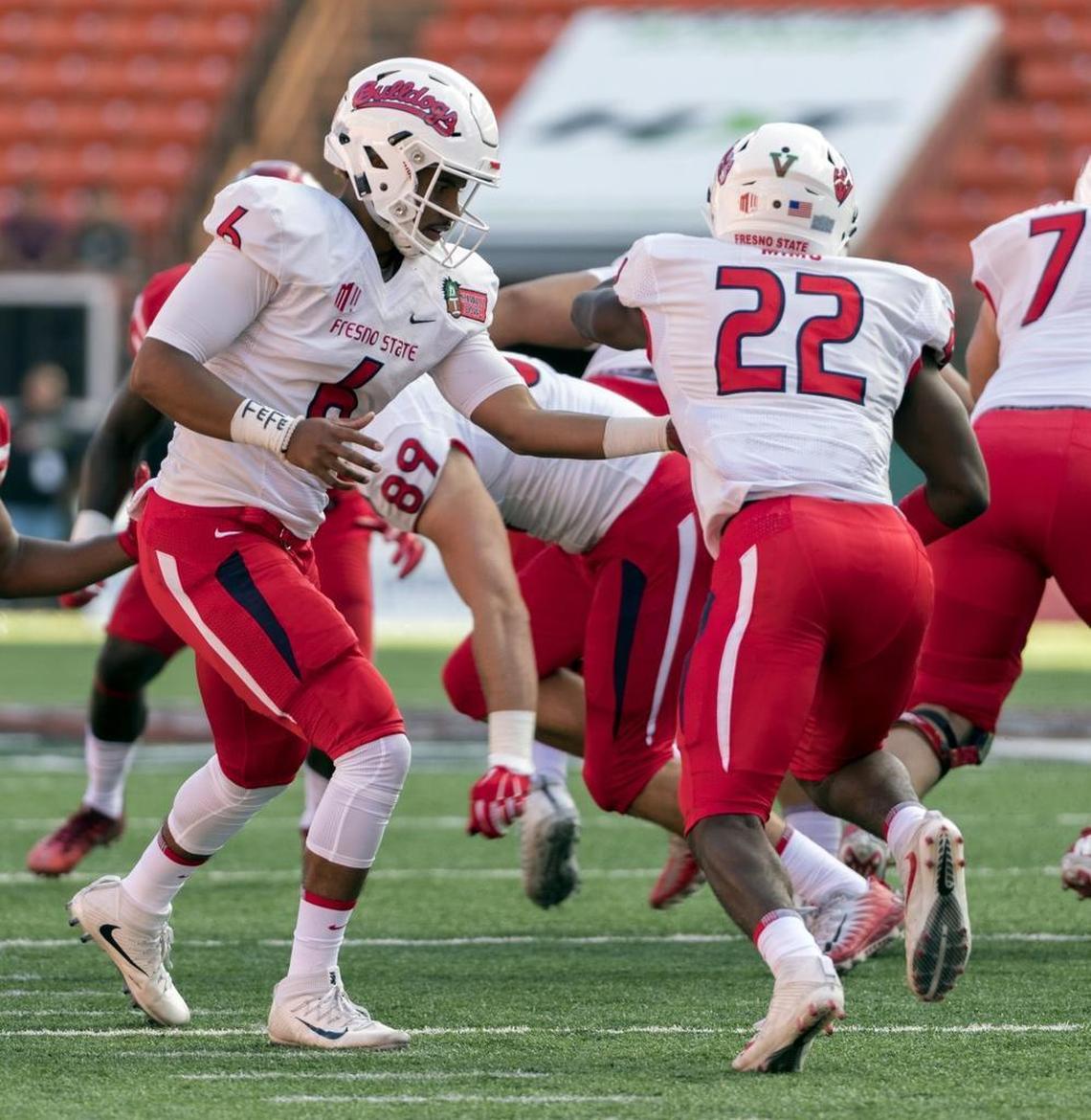 Fresno State quarterback Marcus McMaryion hands of to Jordan Mims in the first quarter of the Bulldogs;’ Hawaii Bowl victory over Houston. Mims last season led the Bulldogs with 627 yards and 4.2 yards per play.