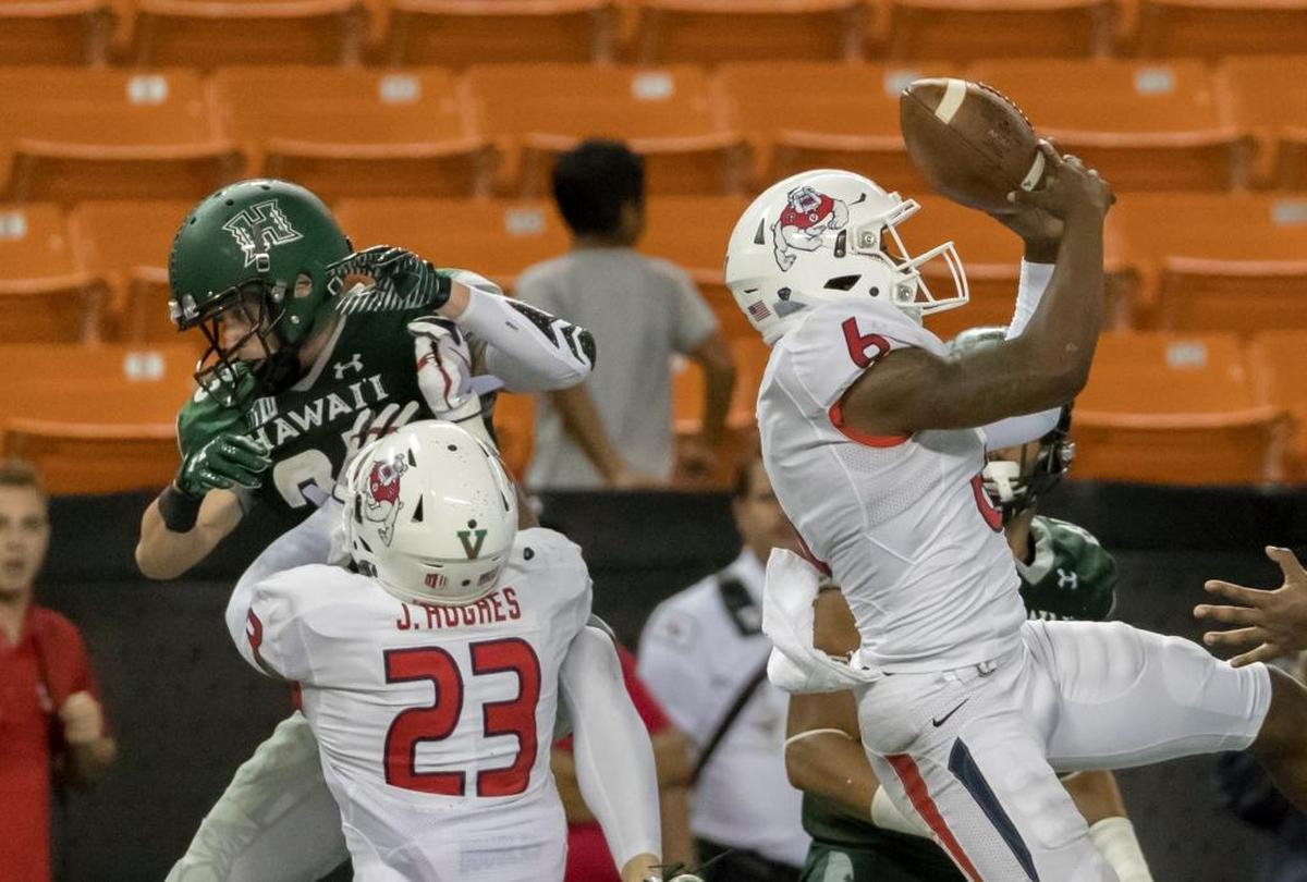 Fresno State cornerback Anthoula Kelly (6) steps in front of Hawaii wide receiver Dylan Collie (23) and safety Juju Hughes (23) to intercept a pass in the end zone in the fourth quarter of the Bulldogs’ victory at Hawaii, Saturday, Nov. 11, 2017, in Honolulu.