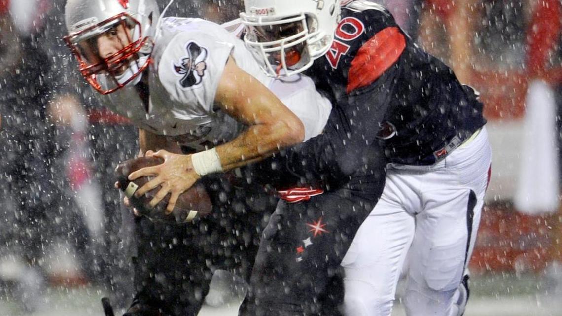 
UNLV quarterback Kurt Palandech is sacked by Fresno State’s Justin Green as a deluge of rain fell late in Friday night’s game at Bulldog Stadium. Green’s fourth-down sack followed one on third down by Ejiro Ederaine, securing Fresno State’s 31-28 win over the Rebels.
