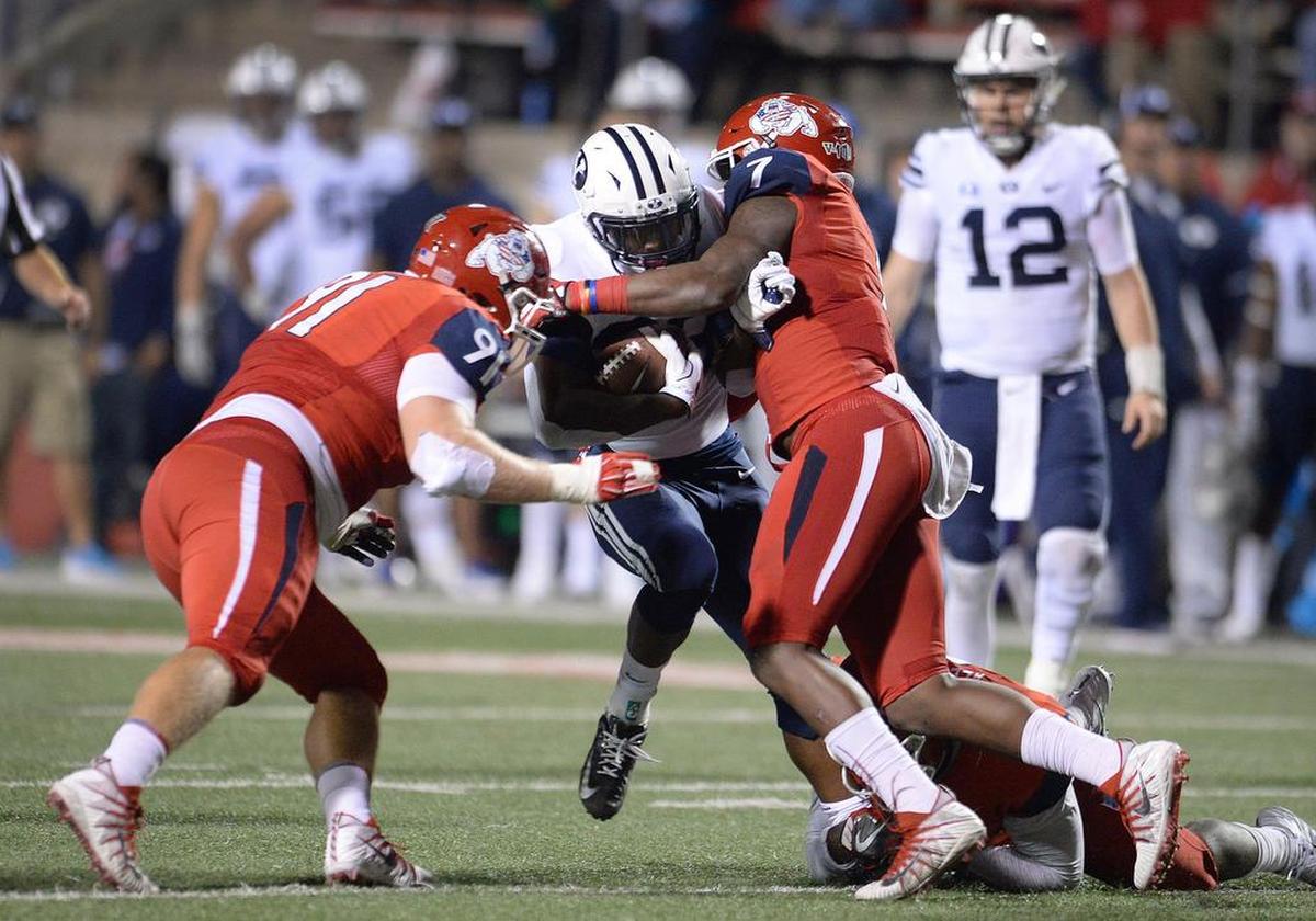 Fresno State linebacker James Bailey (7) and defensive tackle Nathan Madsen (91) take down BYU's Squally Canada at the line of scrimmage during a 20-13 victory over the Cougars last season. The Bulldogs ranked second in the Mountain West Conference in scoring and total defense.