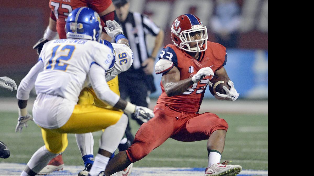 
Fresno State senior Marteze Waller, right, was named to the watch list for the Doak Walker Award, which recognizes college football’s best running back. Waller rushed for 1,368 yards and 11 touchdowns last season.
