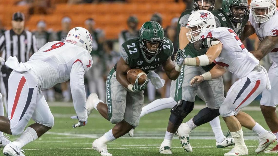 Fresno State linebackers Jeffrey Allison (9) and George Helmuth (34) close a gap on Hawaii running back Diocemy Saint Juste (22) during the first quarter of the Bulldogs’ 31-21 victory, Saturday, Nov. 11, 2017, in Honolulu. Allison and Helmuth both had eight tackles in the game as Fresno State shut down the Hawaii offense. The Rainbow Warriors went in averaging 439.6 yards per game, but had just 272 against the Bulldogs.