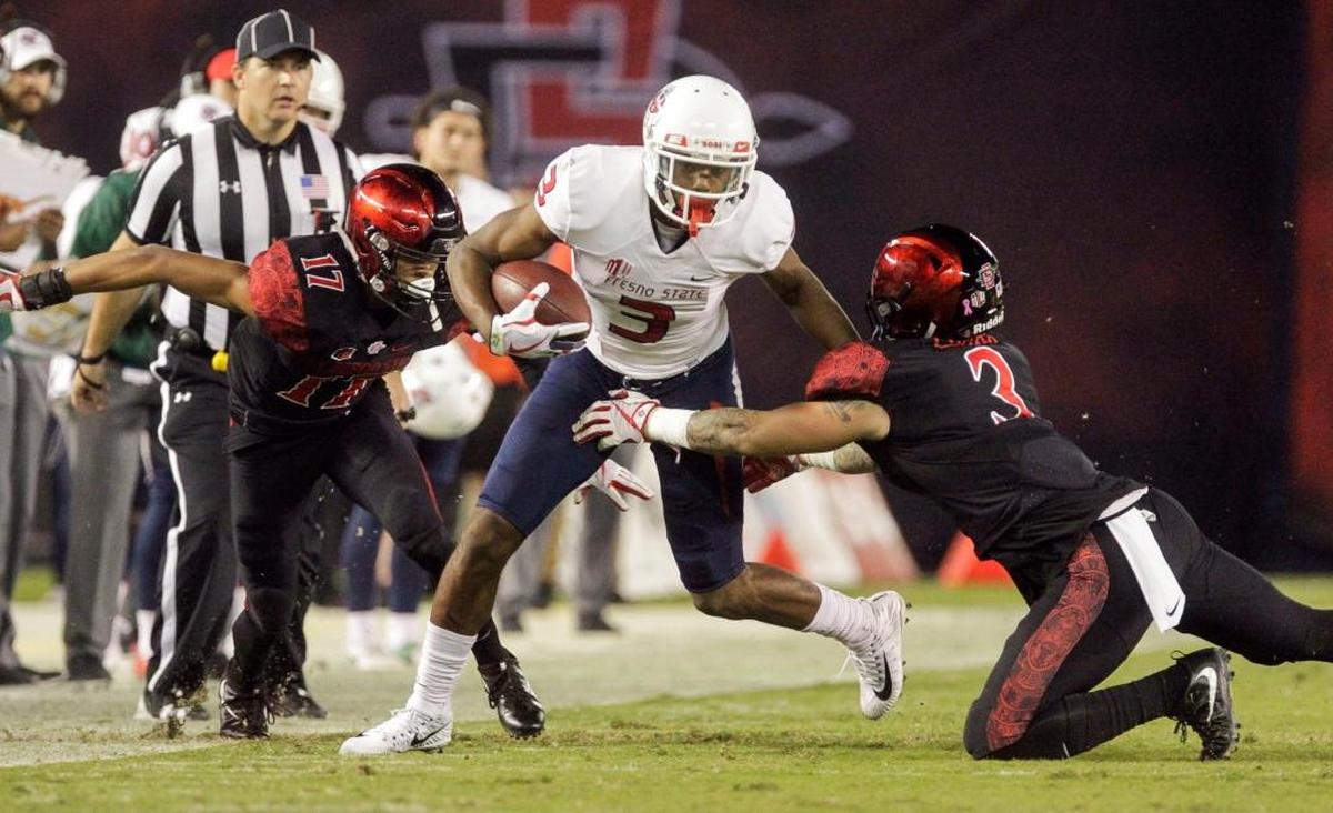 Fresno State wideout KeeSean Johnson tries to elude San Diego State’s Trey Lomax, right, and Ron Smith during the second quarter of the Bulldogs’ 27-3 victory in San Diego on Oct. 21, 2017. Johnson is leading Fresno State with 37 receptions and in games at Bulldog Stadium he is averaging 17.3 yards per catch and has all four of his touchdown receptions.