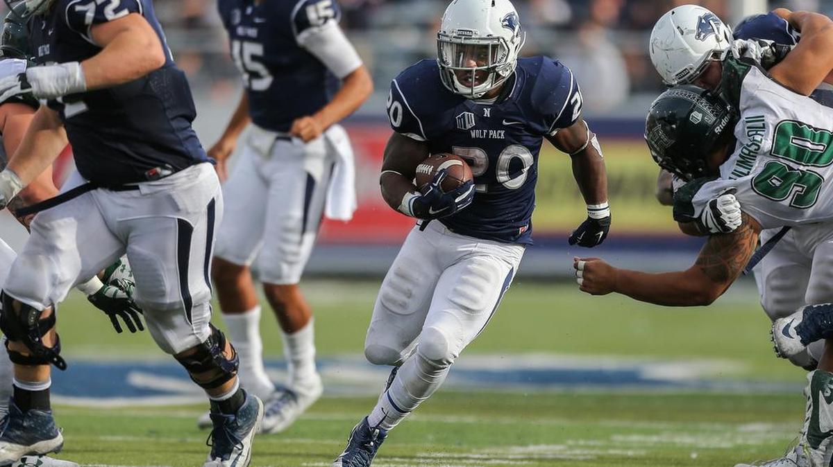Nevada running back James Butler (20) runs through an opening against Hawaii during the second half of an NCAA college football game in Reno, Nev., on Saturday, Oct. 24, 2015.